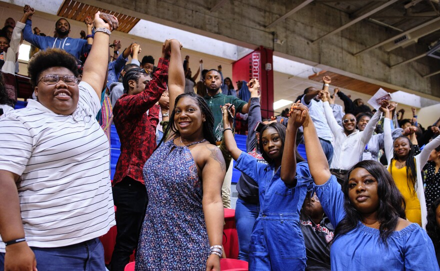 LaKevia Dismal (center, left) and Maya Covington (center, right) celebrate their graduation from the Children's Defense Fund Freedom School training program.