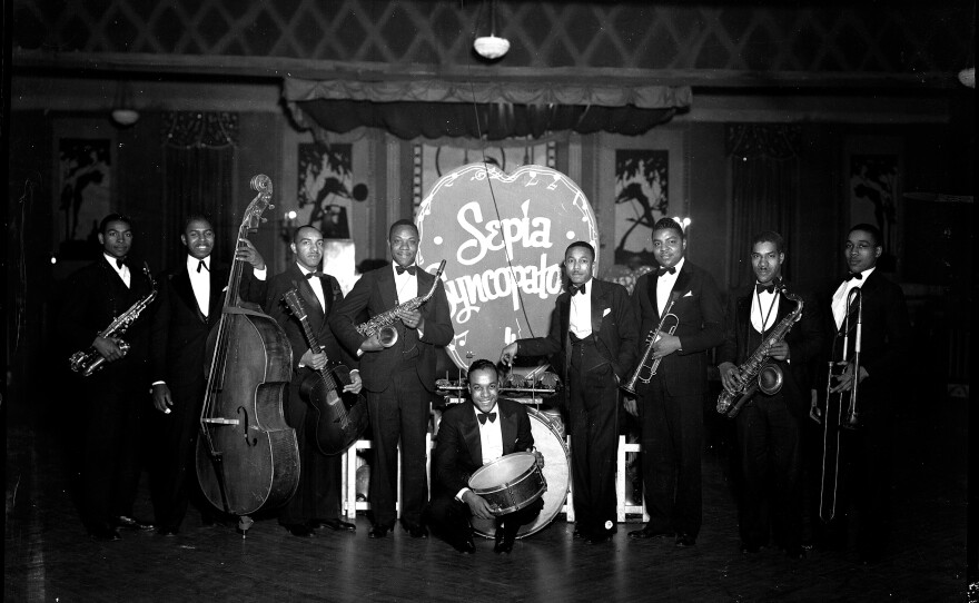 Group portrait of band Sepia Syncopaters with their instruments.