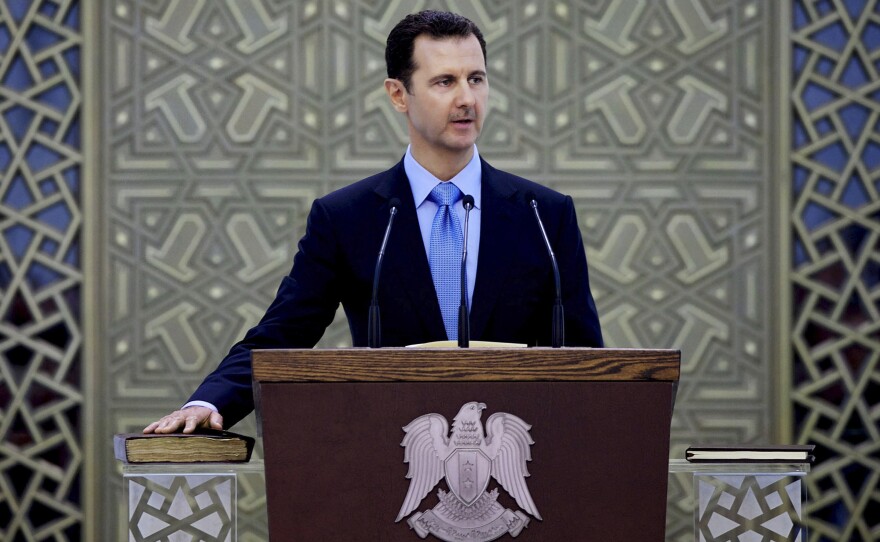 Syrian President Bashar Assad, shown here in July, appeared to be in a tough position at the beginning of the year. But many analysts say his hold on power grew stronger over the course of 2014, due in part to the U.S. bombing campaign against the Islamic State.