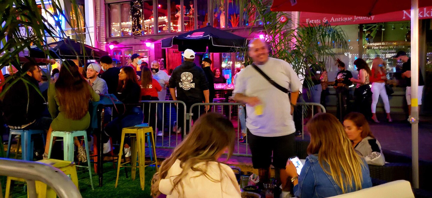 Patrons sitting outside in front of a restaurant in the Gaslamp Quarter.