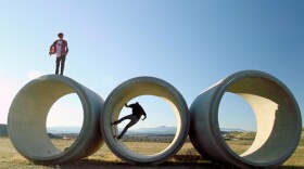 Garrison and Kevin skate outdoors.