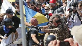 White nationalist demonstrators clash with counter demonstrators at the entrance to Lee Park in Charlottesville, Va., Aug. 12, 2017. 