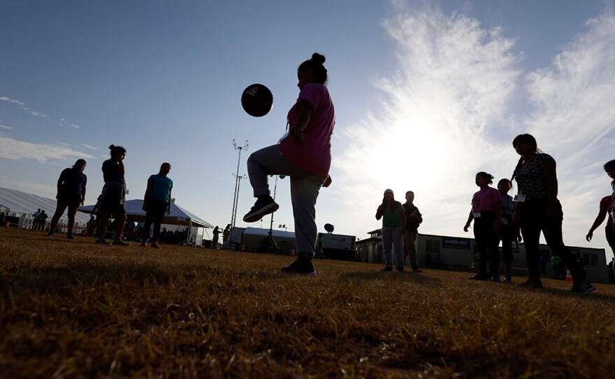 File photo of migrant children playing soccer at the U.S. government's holding center in Carrizo Springs, Texas, July 9, 2019. 