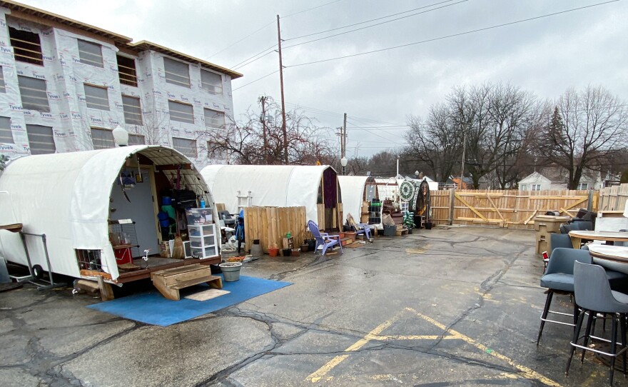Conestoga huts house 22 formerly homeless people at this tiny home village in Madison, Wisconsin, located at the site of a shuttered bar.