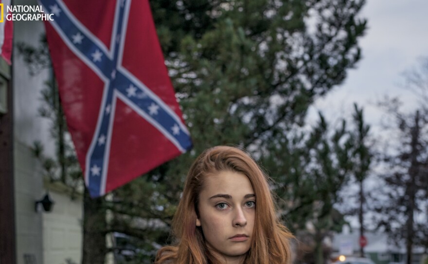 Felyssa Ricco stands outside the house in Hazleton, Pennsylvania, where she lives with her mother and stepfather, Kelly and Jesse Portanova. In addition to flying Old Glory and other flags, such as "Don't Tread on Me," the Portanovas sometimes fly the Confederate flag, saying it's a way of standing up to those who believe it shouldn't be displayed or who want to disregard America's history.
