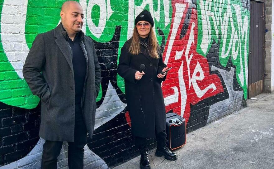 Rodrigo Pradel and Yasi Farazad stand in front of the mural Pradel painted in Washington, D.C. during the unveiling event of the mural on Jan. 15.