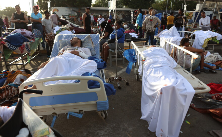 Patients lie outside a hospital evacuated after it was damaged in an earthquake in Catia La Mar, Venezuela, Thursday, June 25, 2026.