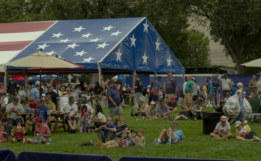 Attendees watch a live streaming of the practice races on the National Mall during the Freedom 250 Grand Prix.