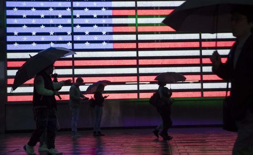 People holding umbrellas walk through New York City's Times Square in 2019. The U.S. Census Bureau plans to change how it protects the confidentiality of people's information in the detailed demographic data it produces through the 2020 count.