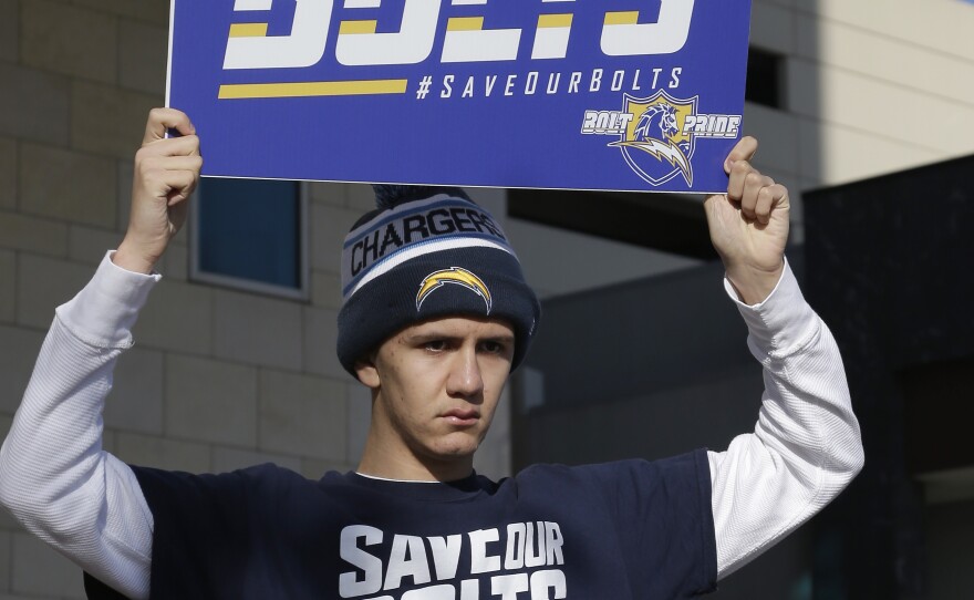 San Diego Chargers fan Richard Farley shows his feelings about keeping the NFL team in San Diego as he holds a sign that reads, "Save Our Bolts." Farley is outside the hotel where NFL owners are meeting in Houston to discuss possible relocation to Los Angeles, Jan. 12, 2016.