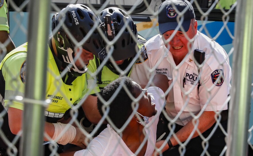 A protester is arrested  by NYPD officers during a march in Manhattan on Wednesday.
