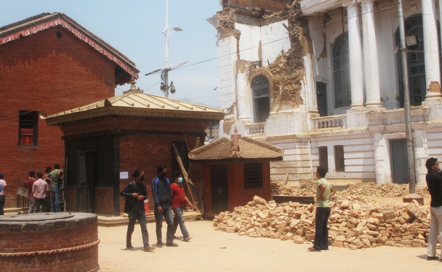 In last month's devastating earthquake, the Kumari's home (left) remained intact, suffering only minor cracks, while surrounding buildings in Kathmandu's historic Durbar Square were badly damaged or destroyed.