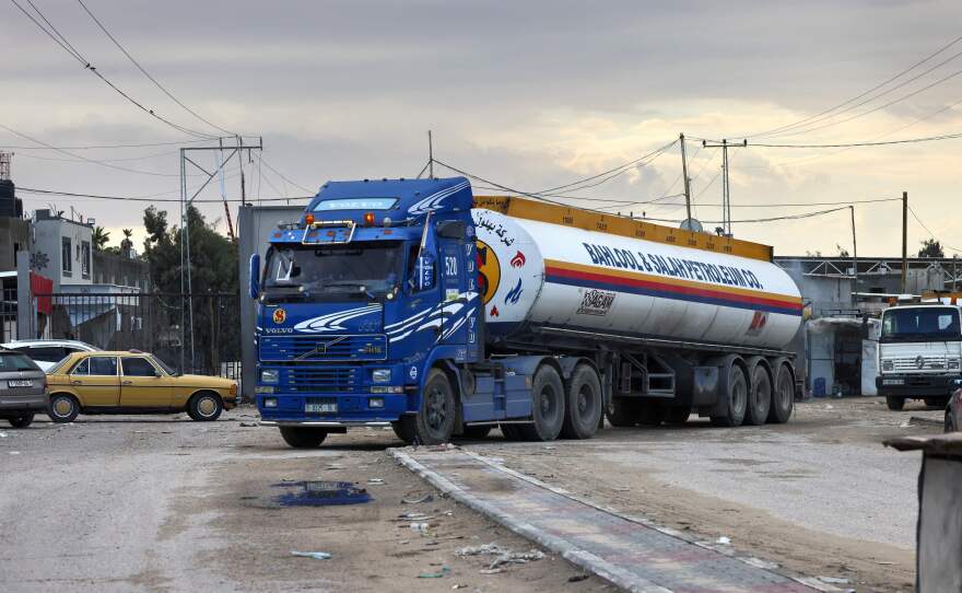 A truck carrying a limited delivery of fuel crosses into Rafah in the southern Gaza Strip on Wednesday. Israel has agreed to allow in a greater amount of fuel for humanitarian use.