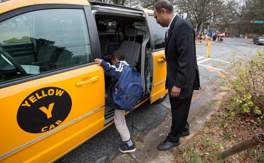 Most days, Shekhey uses his taxi to help transport refugees who have no other transportation and to shuttle children to an after-school program he runs at a local church. Here, he picks up Milkeso Sayida, 8, from Indian Creek Elementary School.