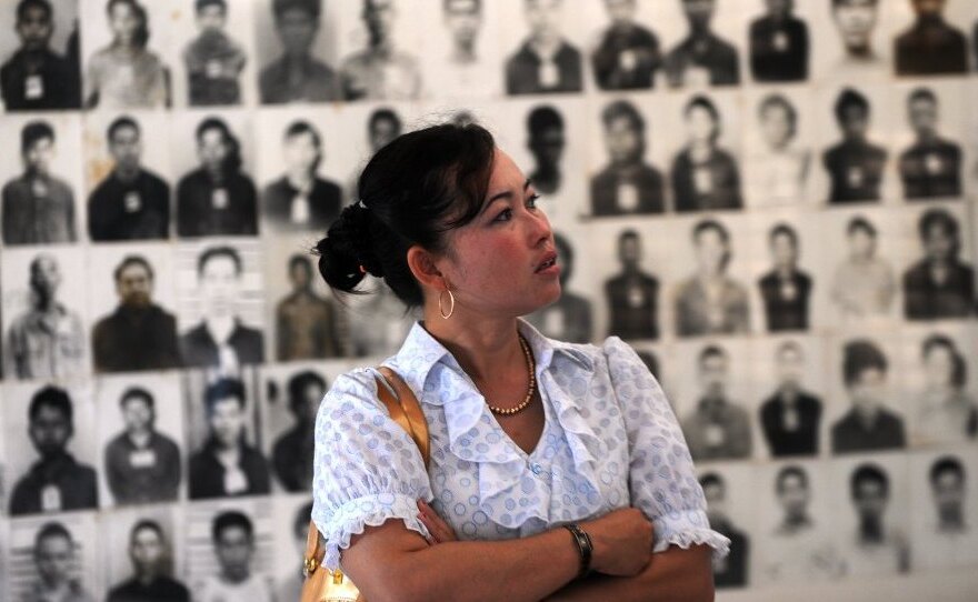 A Cambodian woman looks at portraits of Khmer Rouge victims at the Tuol Sleng genocide museum in the capital Phnom Penh on Nov. 17. Three senior Khmer Rouge leaders are on trial in what may be the last major legal case against the group's leaders.