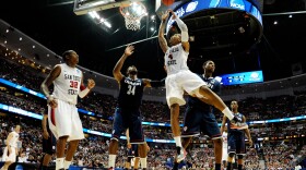 Malcolm Thomas #4 of the San Diego State Aztecs handles the ball against Alex Oriakhi #34 of the Connecticut Huskies during the west regional semifinal of the 2011 NCAA men's basketball tournament at the Honda Center on March 24, 2011 in Anaheim, California. 
