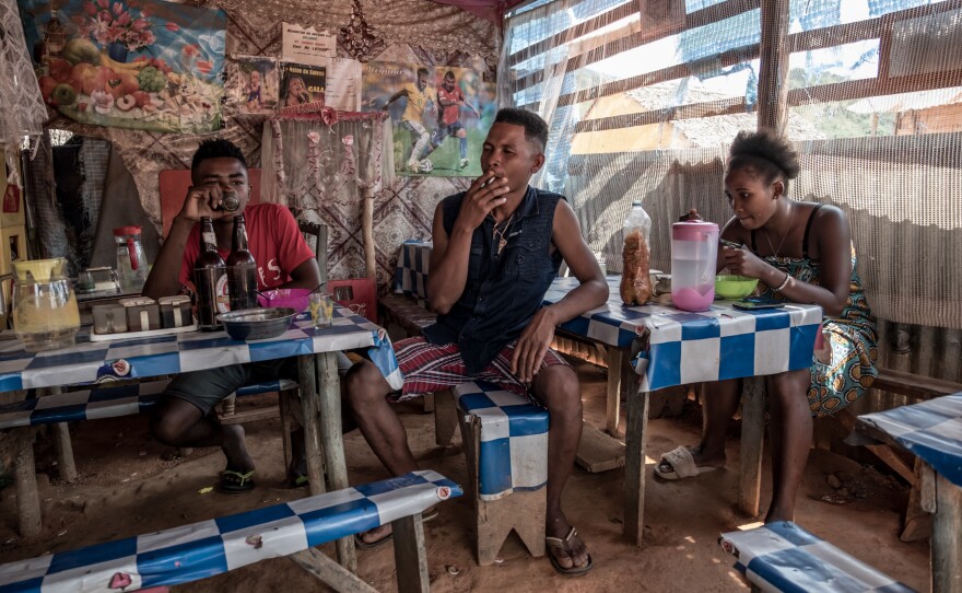 People eat lunch in a small restaurant owned by vanilla farmer Beny Odon in Belambo, Madagascar.