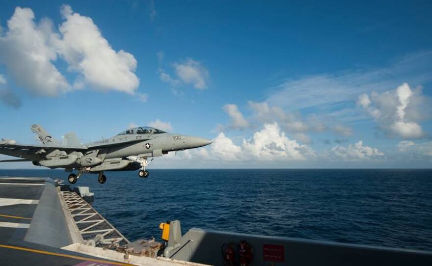 An EA-18G Growler from the Cougars of Electronic Attack Squadron (VAQ) 139 launches from the flight deck of the Nimitz-class aircraft carrier USS Carl Vinson (CVN 70), October 2014.