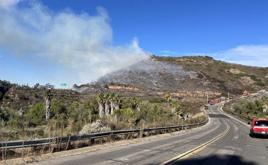 A brush fire burns close to Interstate 15, Oct. 30, 2023.