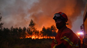 Firefighters battle a blaze outside Lanton, during wildfires in southwestern France, Tuesday, July 28, 2026.