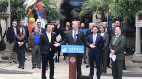 San Diego Mayor Kevin Faulconer speaks at a podium outside of the Mingei International Museum in Balboa Park, May 1, 2018.