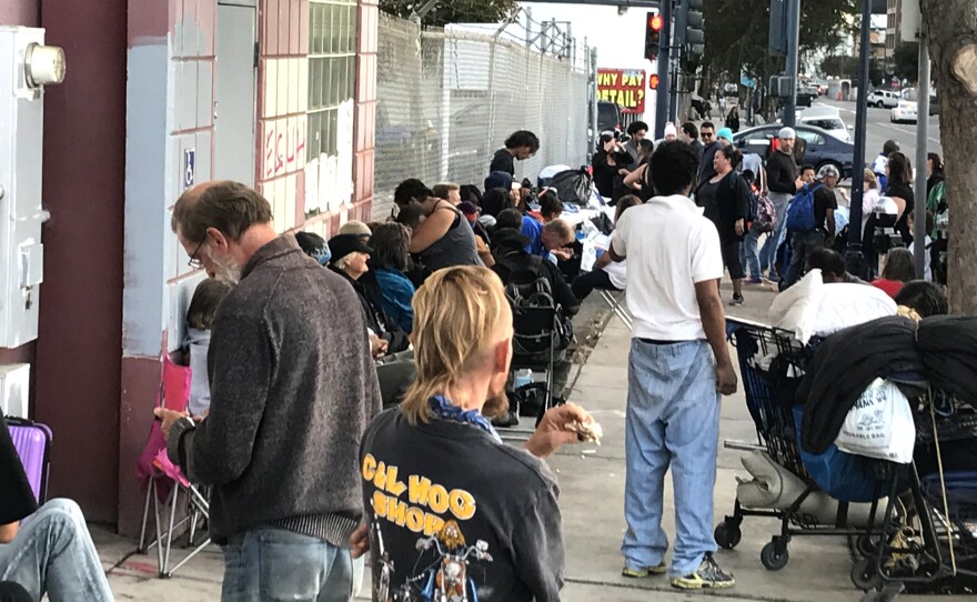 People line up along 15th Street downtown for Streets of Hope's Thanksgiving Feed the Homeless event, Nov. 20, 2017.