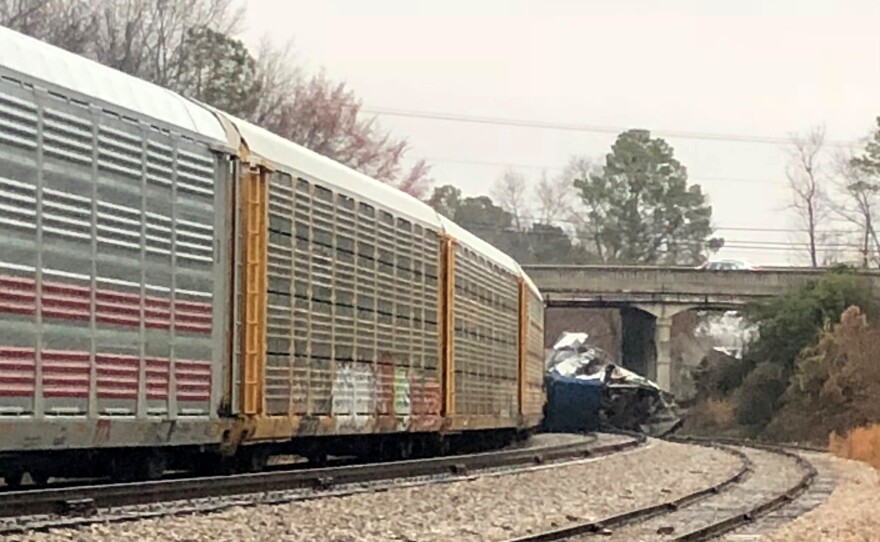 A derailed Amtrak train sits on the track in Cayce, S.C., on Sunday. The Amtrak passenger train slammed into a freight train parked on a side track killing two Amtrak employees and injuring more than 100 people, authorities said.