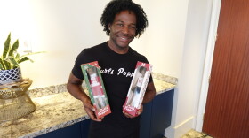 Curls Poppin' CEO Ashley Head holds two Curls Poppin' dolls on Sept. 22, 2026, at the University Club of San Diego.