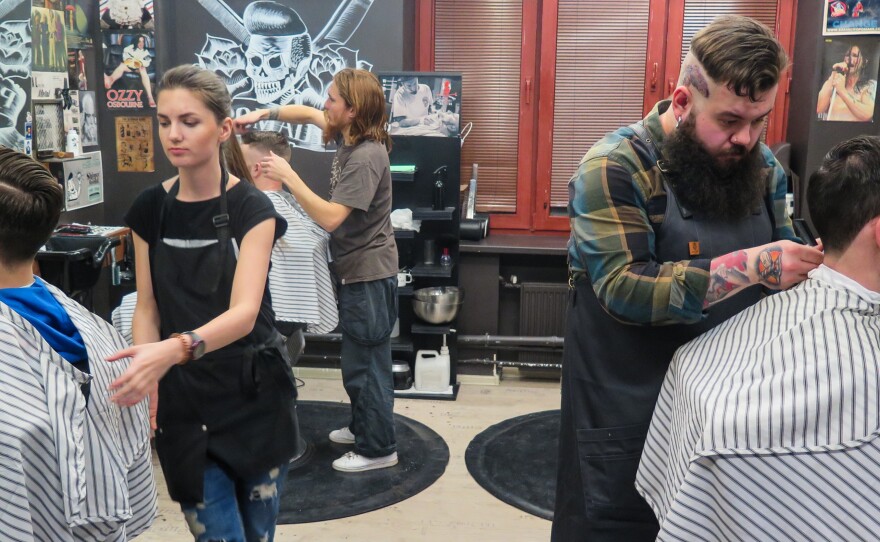 In Moscow, young people who never knew the conformism of the Soviet Union are developing their own styles. Artemy Zolotarevsky, right, cuts a customer's hair at Pomades, one of several new men's salons that have opened recently in the Russian capital.