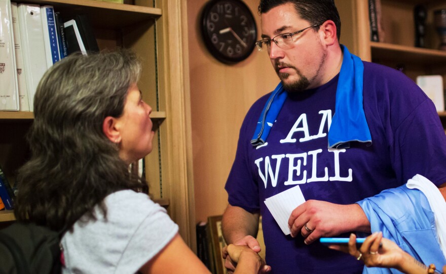 Corinna Anjali (left) speaks to Ferguson, Mo., Mayor James Knowles after the event. "You're in the hot spot as the one person in power," Anjali said to Knowles. "It's important for you to say, 'I hear you' to the people who have been hurt."
