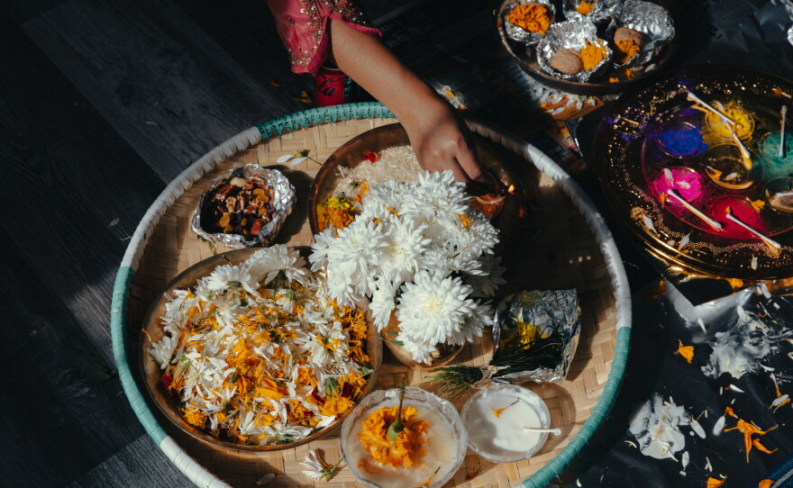 Manju Gurung prepares a plate for offering blessings amid festivities in honor of Tihar, the Hindu festival of lights and animals, in Mount Holly Springs, Pa., on Oct. 23, 2025. A part-time volunteer coach for the Soccer for Success program, Gurung also helps lead the civic engagement arm of ARU to educate their community on their rights and voting power.