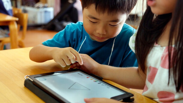FILE - Children work on a digital program at Coby Preschool in Yoshikawa, suburban Tokyo, July 12, 2018. (AP Photo/Yuri Kageyama, File)