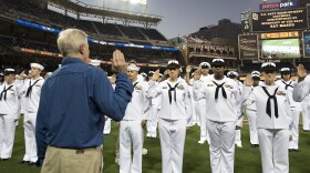 Ray Mabus administers the oath of enlistment to 91 Sailors from the San Diego area during a reenlistment ceremony before a Major League Baseball game between the San Diego Padres and the Los Angeles Dodgers at Petco Park. Mabus also threw out the ceremonial first pitch before the game.