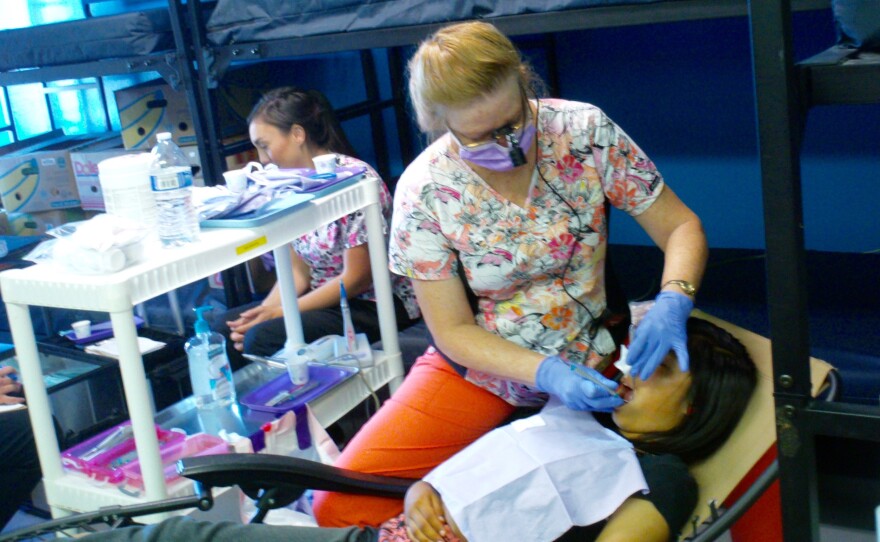 Melody Swaroop, RDHAP, provides free teeth cleaning at the North County Homeless Connection event on Oct. 10, 2015. Services were set up in a room used as a winter shelter at the Bread of Life Rescue Mission.