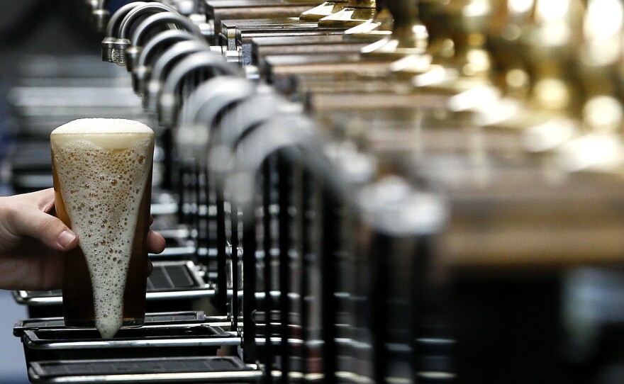 A pint of beer is poured at the 2015 Great British Beer Festival in London. A brewery in the northeast of England is giving away beer to help raise money for the National Health Service during the coronavirus pandemic.