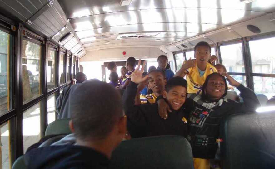 Kids on the Mo Better Jaguars football team board a bus in Brownsville, Brooklyn to go to a game in September 2014.