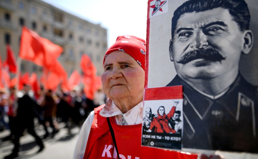 A Russian Communist Party activist carries a banner with a portrait of late Soviet leader Joseph Stalin during a May Day rally in central Moscow on Monday.