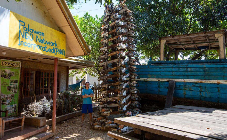 Bobby Chan stands in front of the tree made of confiscated chainsaws at PNNI HQ - April 2018
