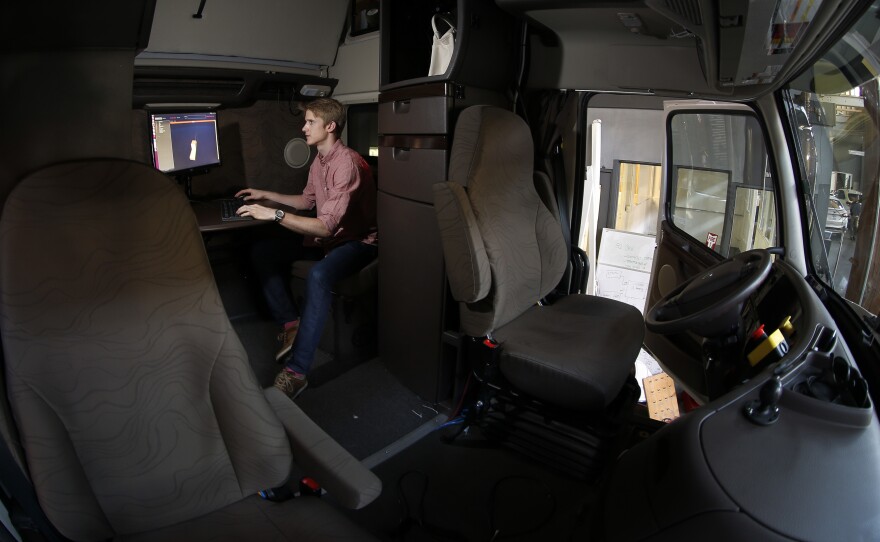 Don Burnette, senior staff engineer at Otto, checks the software on a computer in the back of the self-driving, big-rig truck. Self-driving trucks could make the lives of truckers safer and less stressful.