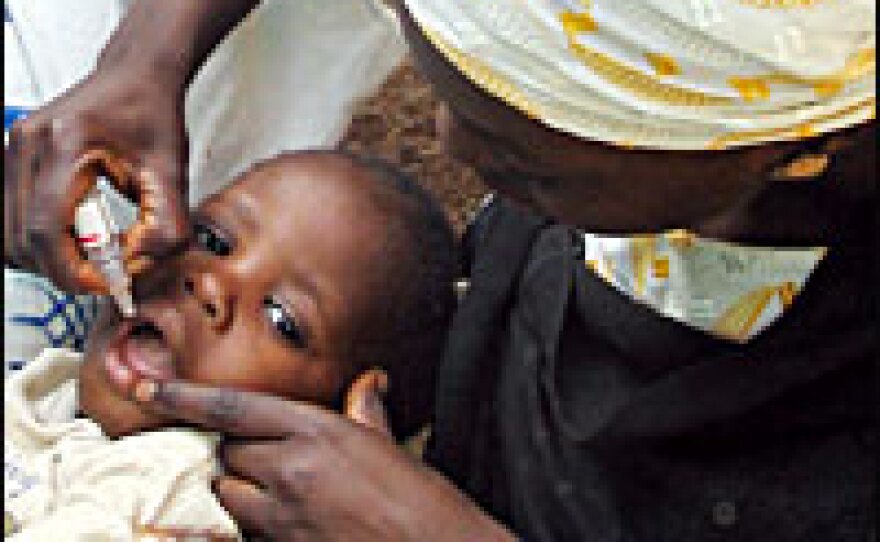 The oral polio vaccine is administered to a Nigerian child.