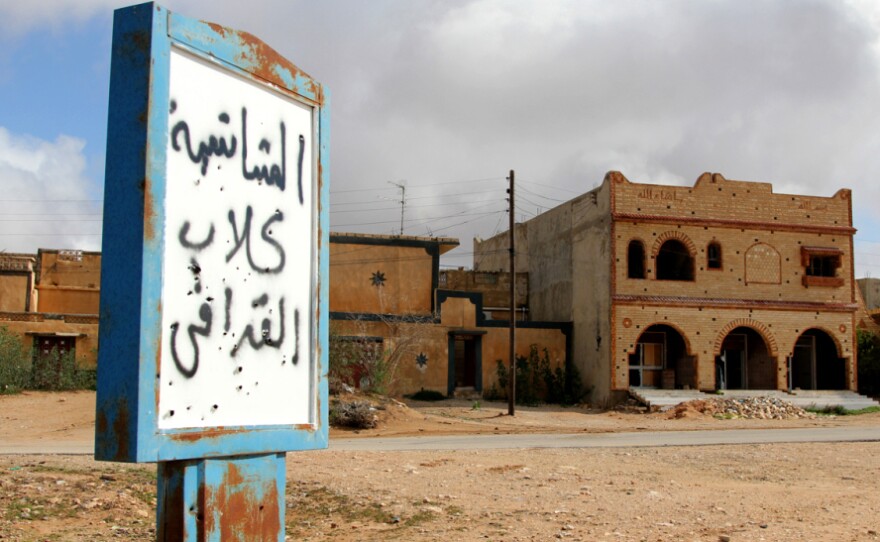 A sign in the abandoned village near Zintan reads, "Mushashya: Gadhafi dogs." 