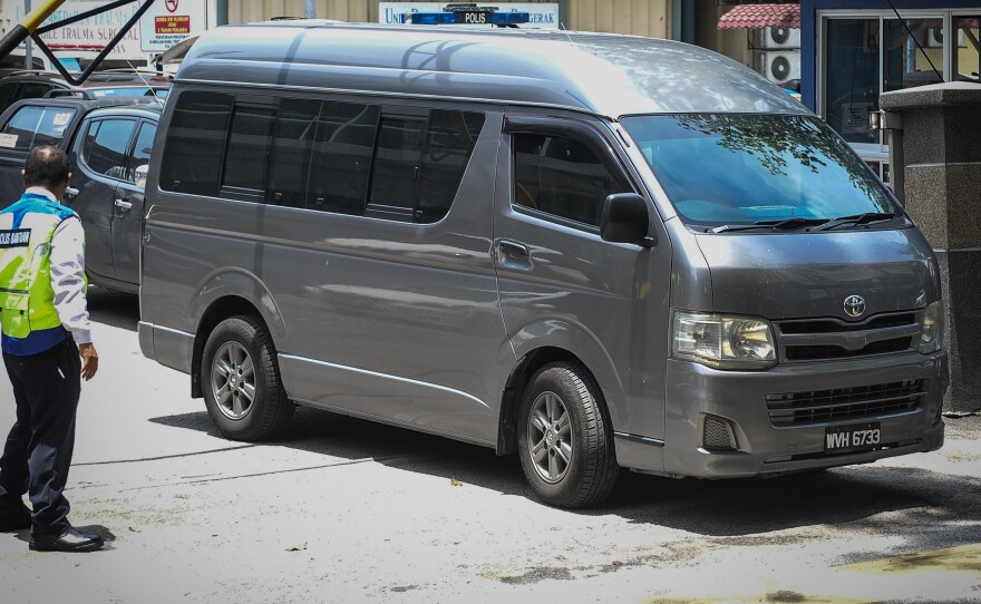 A van believed to be carrying the body of Kim Jong Nam, the half-brother of North Korea's leader, leaves the forensics wing of a hospital in Kuala Lumpur Thursday. Malaysia released the body along with men who had been questioned over Kim's death.