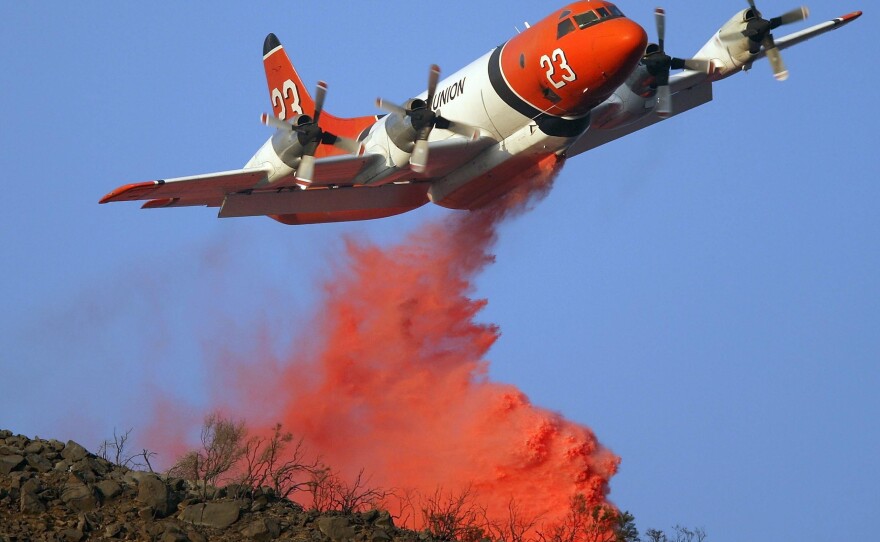 A firefighting air tanker drops fire retardant on the Tea Fire in Montecito, Calif. in 2008. In 2000, The U.S. Forest Service had contracts for 43 air tankers. These days, that number is only nine.