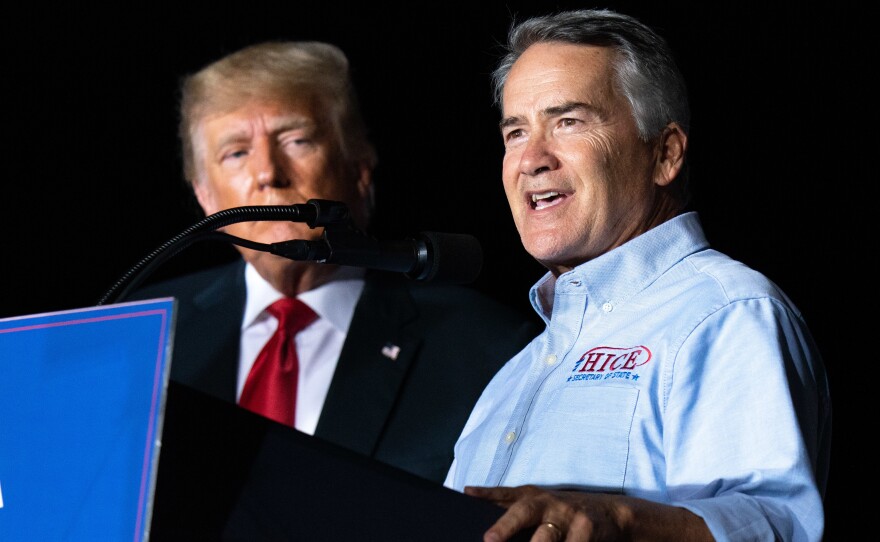 Georgia Rep. Jody Hice speaks during a rally last September as former President Donald Trump looks on. Trump endorsed Hice, who falsely believes fraud tainted the 2020 election, in the Georgia secretary of state race, but Hice was defeated.