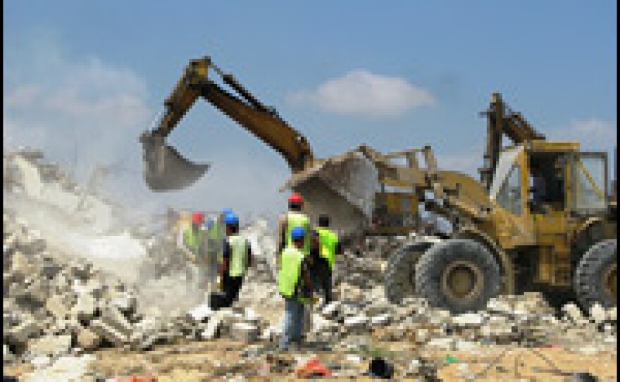 Heavy equipment begins the process of removing rubble from homes in the village of Izbet Abed Rabo, northwest of Gaza City. The buildings were destroyed in the Israeli military operation in late 2008 and early 2009.