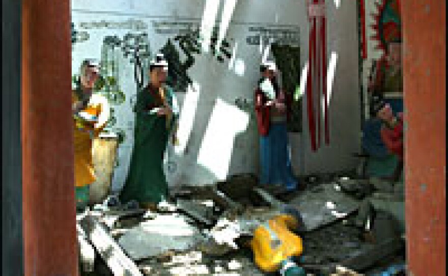 Brightly painted statues are seated serenely in the 18th century Qing Dynasty Taoist Temple in Bai Xi, but the once-ornate surrounding structure is now a pile of bricks and fallen timbers.