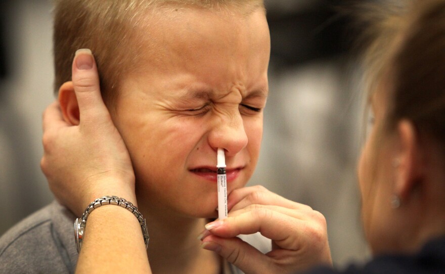 An elementary school student Shane Shorter gets a a dose of FluMist in Gainesville, Fla.