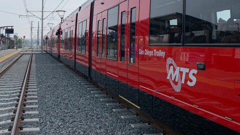 A red MTS trolley car sits at the Balboa Avenue station on the extension of the UCSD Blue Line, Nov. 18, 2021.