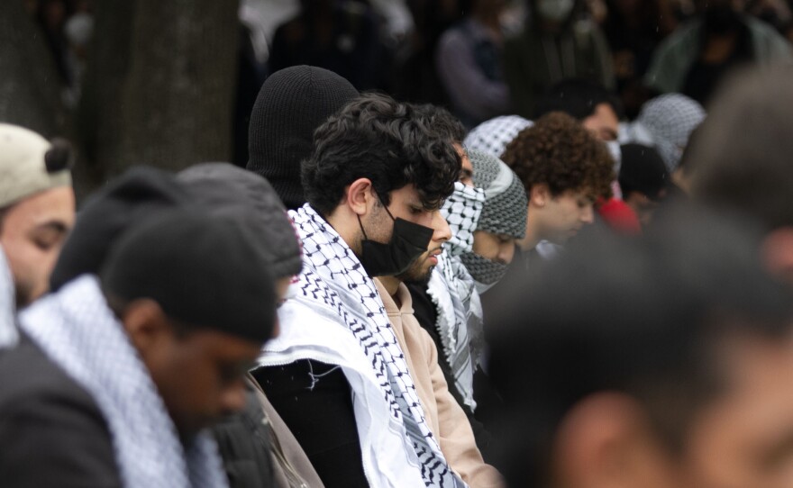 People sit in prayer at a protest for Gaza at UCSD in San Diego, Calif. March 6, 2024.