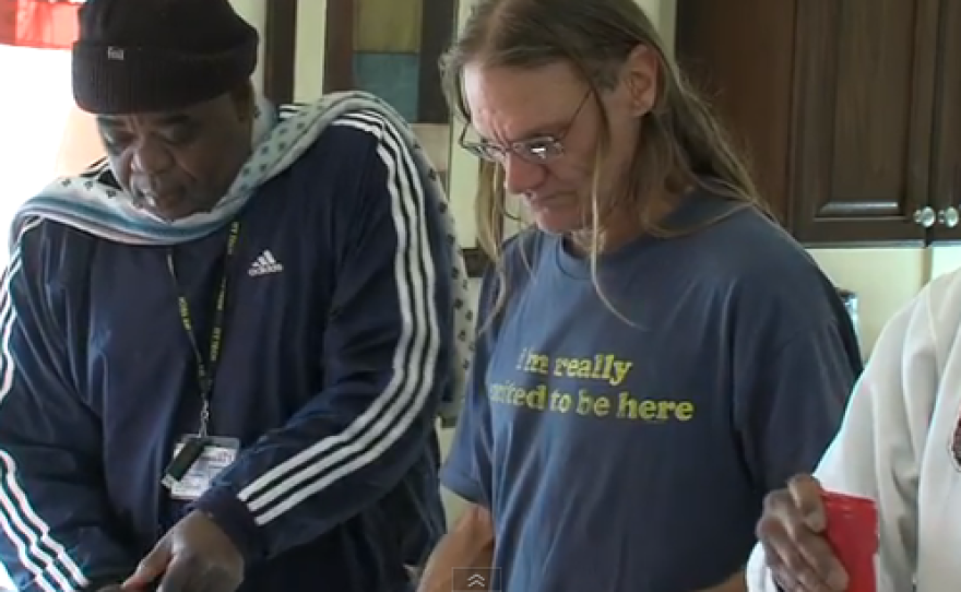 Safe Haven resident John Scarborough serves himself lunch next to other residents of the homeless shelter for the mentally ill.